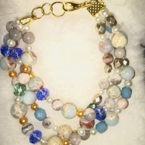 A handmade 3 strand bracelet with gold plated clasp